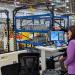 Jonathan Hurst of Agility Robotics inside the RoboFab factory pointing to Digit the robot.